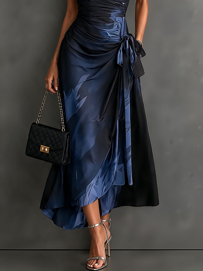 Rosalie | Vestido midi cruzado con estampado abstracto, escote en V, manga corta, cinturón y bajo asimétrico con volante